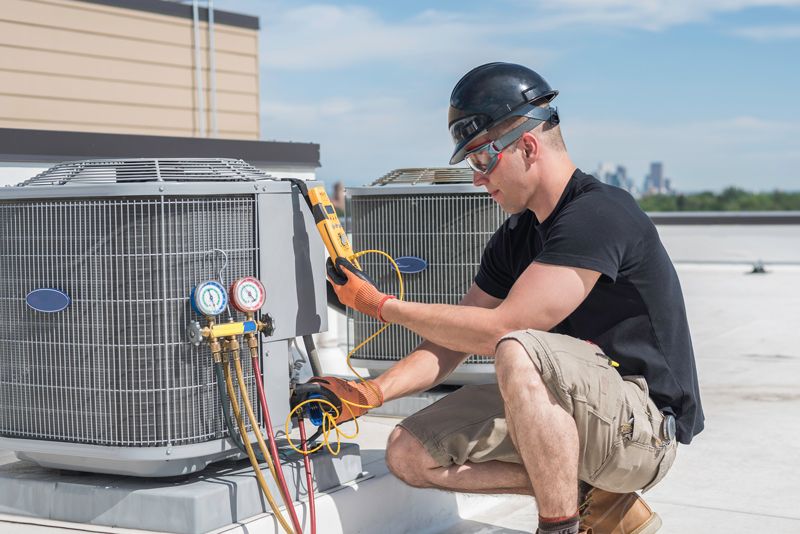 Reliable AC Solutions HVAC Technician Repairing Commercial AC