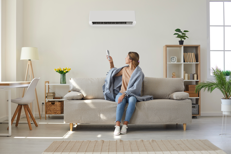 Reliable AC Solutions Woman Using AC Residential Houston