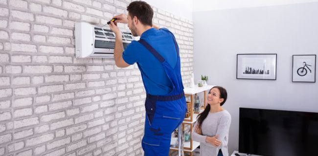 Smiling woman watching residential HVAC installation - Reliable AC Solutions